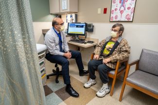 Doctor talking to patient in exam room