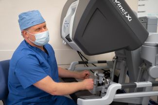 Dr. Steven Nurkin sits at the Da Vinci robotic system before his 500th surgery - April 2021