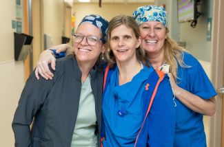 Nurses hugging in a hallway