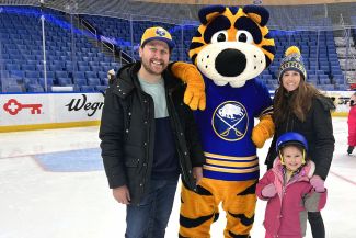 Family posing with Sabretooth on the ice