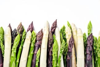 A handful of green, white and purple asparagus 