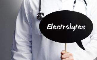 Physician holding sign that reads electrolytes