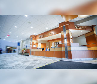 Photo of the main hospital lobby, information and valet desk when you first enter Roswell Park.
