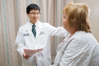 A doctor consults with a patient about breast cancer treatment. 